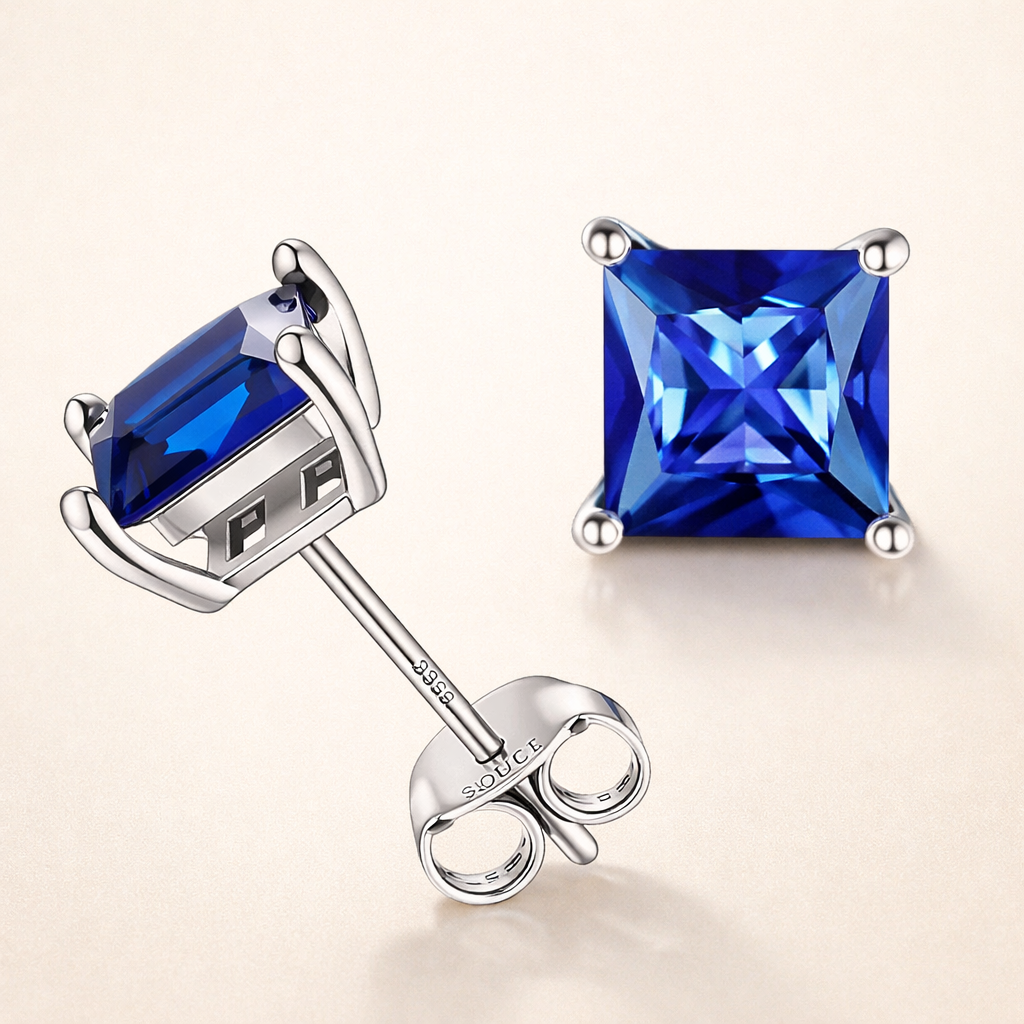 Eleganta örhängen i vitguld med safir i princesslipning