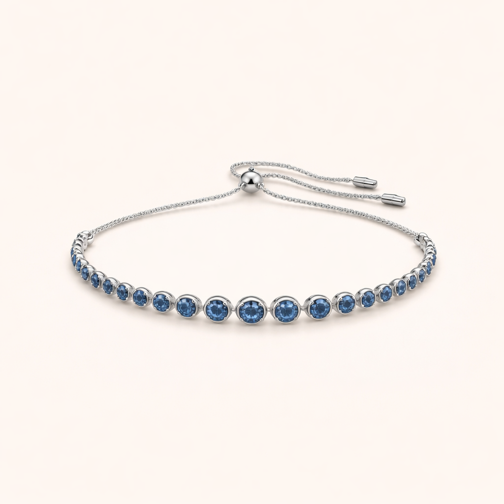 Elegant tennisarmband i vitguld med slipad safir