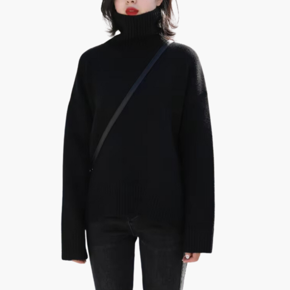 Damebluse med lange ærmer, høj hals og ribbet struktur.