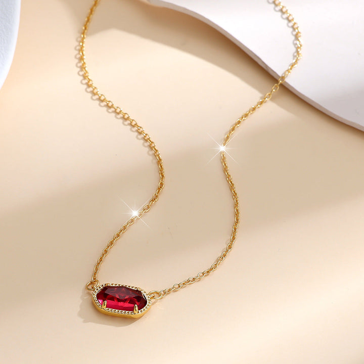 Elegant guldhalsband med oval rubin