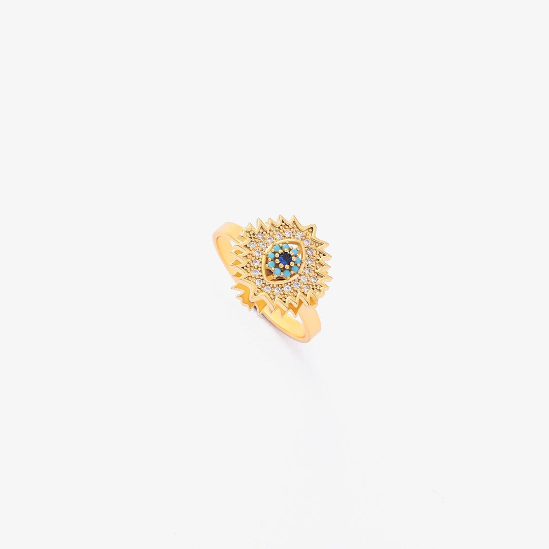 Vriden guldring med safir och solstrålsdesign