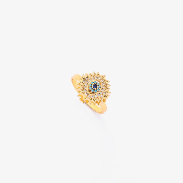 Vriden guldring med safir och solstrålsdesign